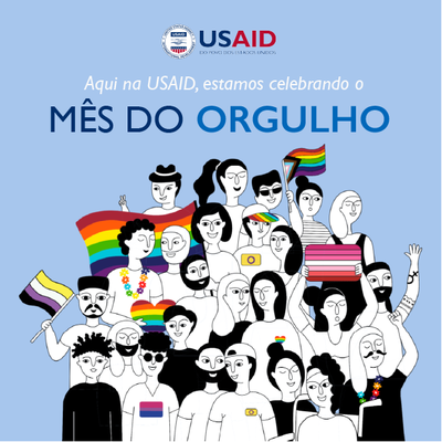 Card mostra desenho representando pessoas segurando bandeiras coloridas e a frase Mês do Orgulho