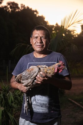 Frederico is an Indigenous man and holds a chicken